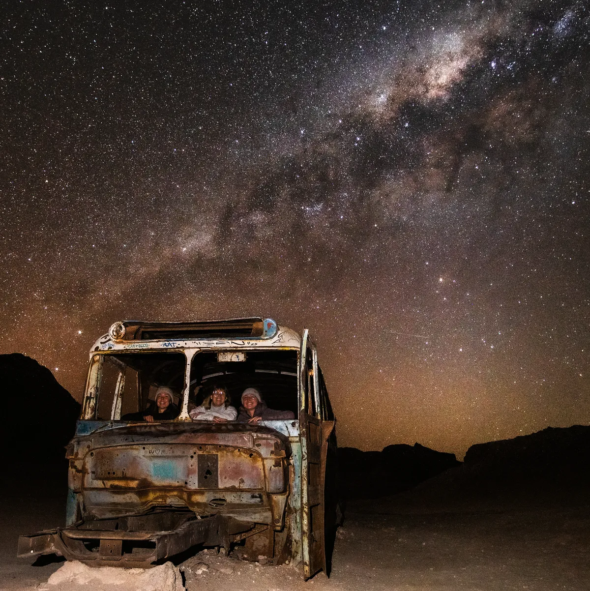 Abandoned bus under the Milky Way in Atacama